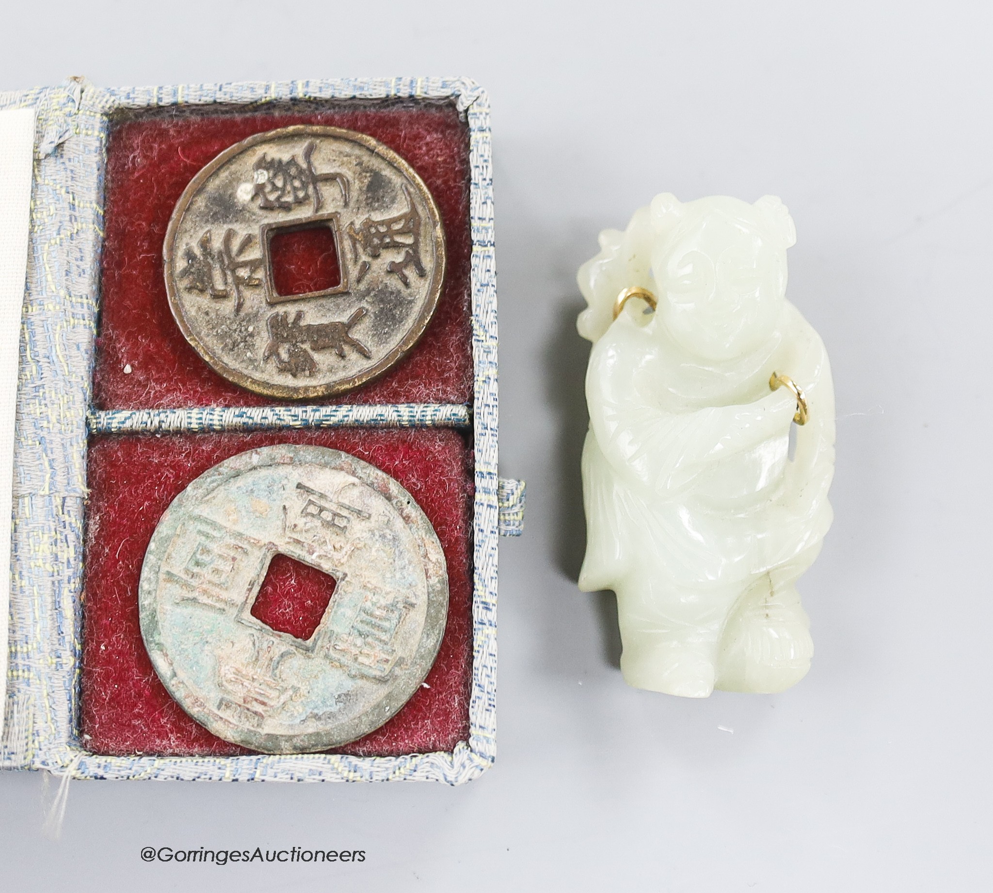 Two Chinese coins and a white jade brooch, 6cm